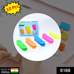 Paper clips displayed on a surface, used for organizing and securing clothes